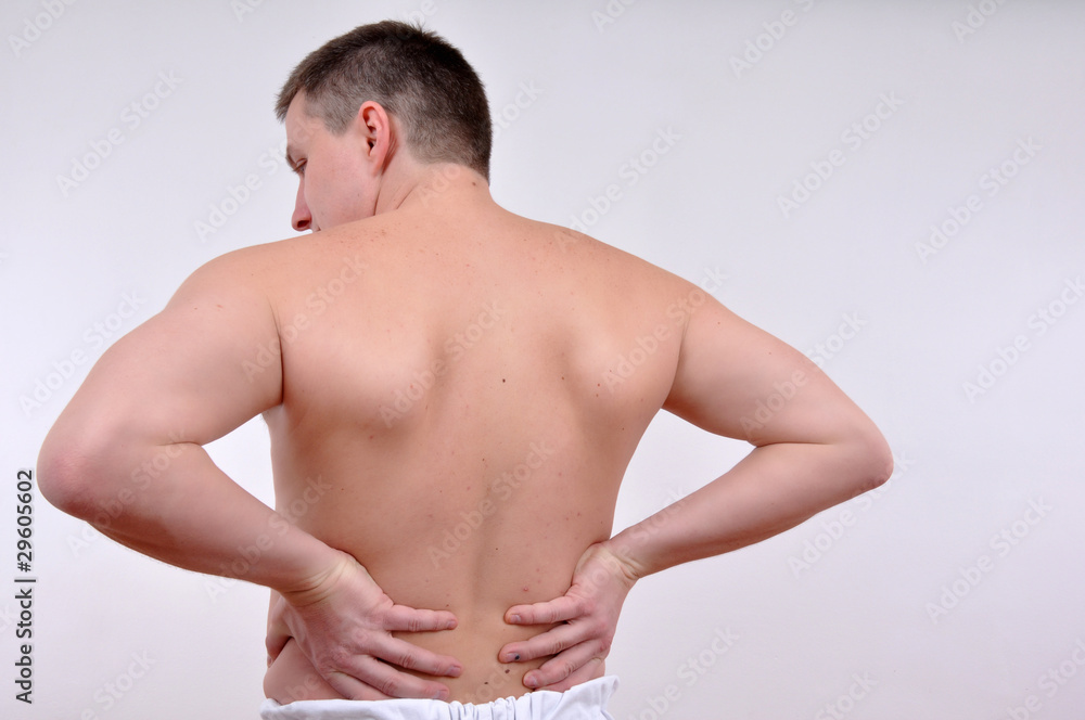 young caucasian man with pain in a back isolated on white