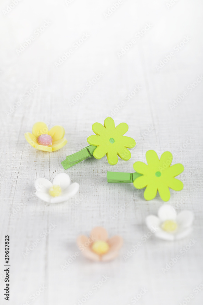 decorative flower pegs with sugar flowers on white old table