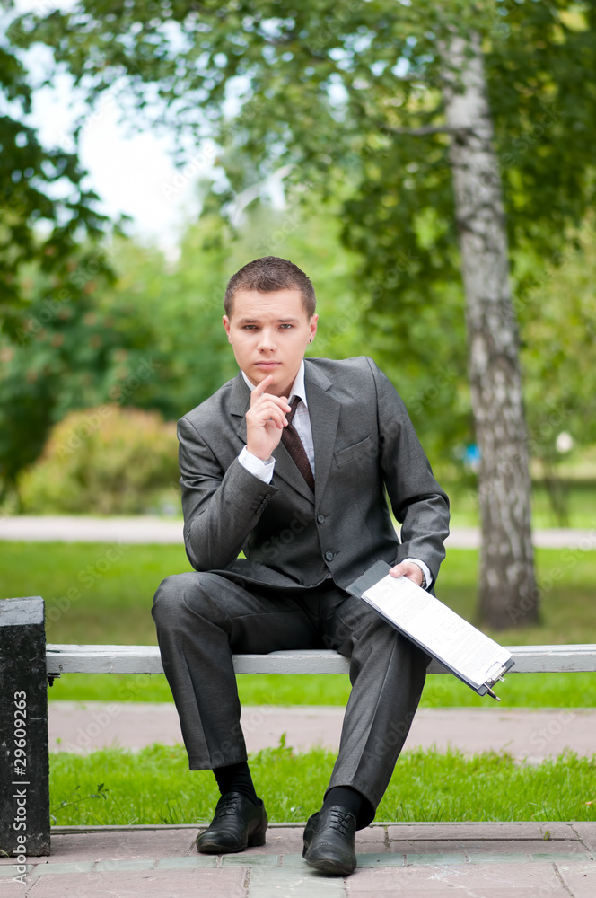 business man working with papers at park. Student business man working with papers at park. Student