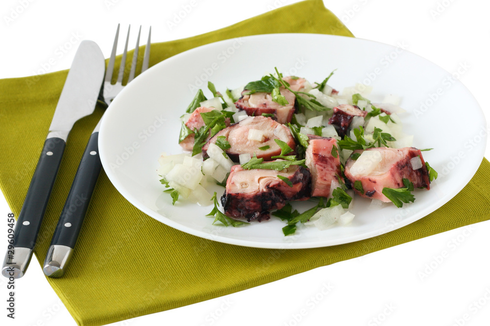 octopus salad with parsley on an white plate octopus salad with parsley on an white plate