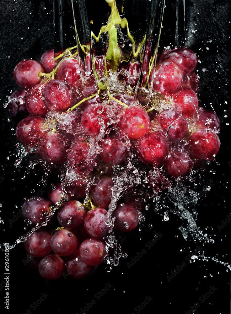 Grapes cluster in water splashes Grapes cluster in water splashes
