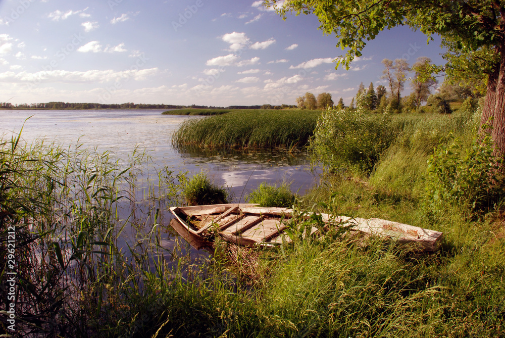 Romantic image of the summer with an old broken boat Romantic image of the summer with an old broken boat