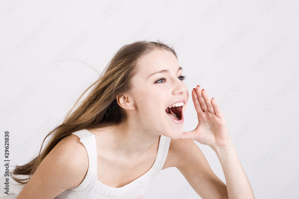 The girl shouts, having combined hands in a megaphone. The girl shouts, having combined hands in a megaphone.