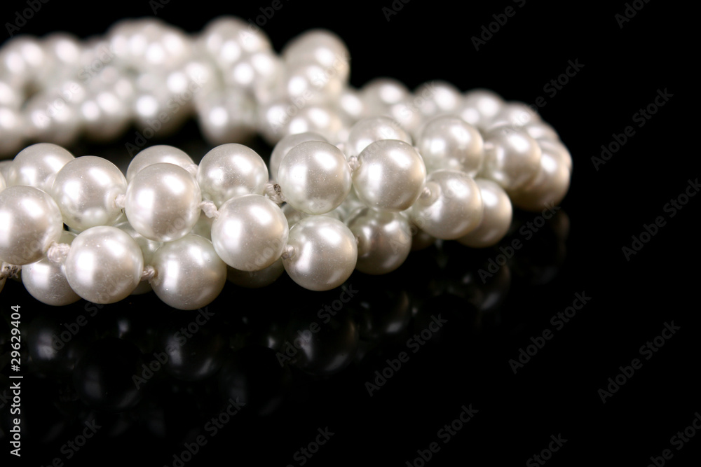 White pearls on black background White pearls on black background