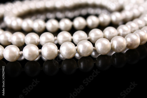 White pearls on black background