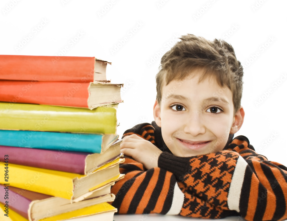 Smiling boy with school books on the table Smiling boy with school books on the table