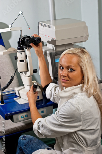 Young woman examining the eyesight