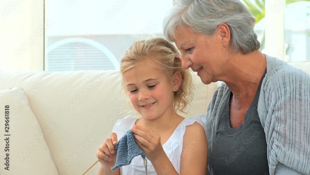 Grandmother with her grand daughter knitting at home Grandmother with her grand daughter knitting at home