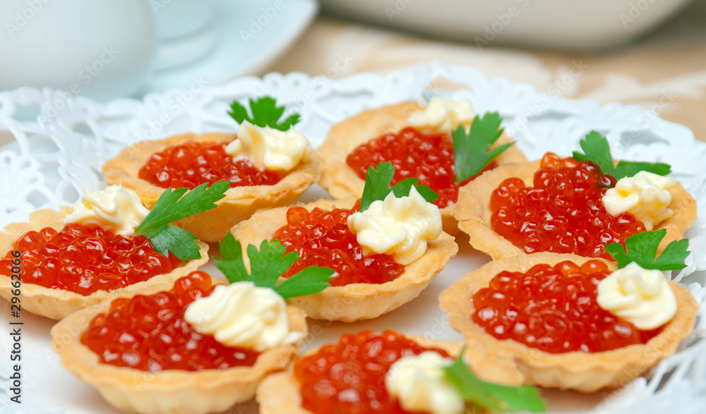 Tartlet with red caviar . Tartlet with red caviar .