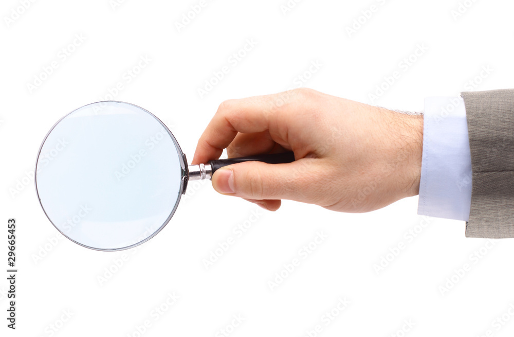 Magnifying glass in hand isolated on white background Magnifying glass in hand isolated on white background