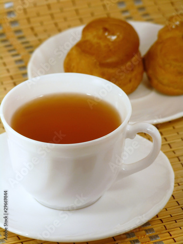 Brewing delicious cake with cream and a cup of tea