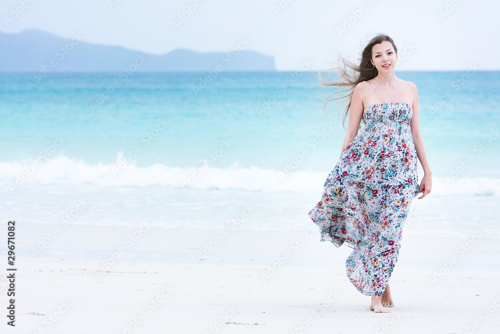young attractive woman walking on beach young attractive woman walking on beach