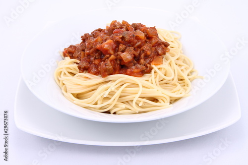 Spaghetti bolognese on a plate on a white background