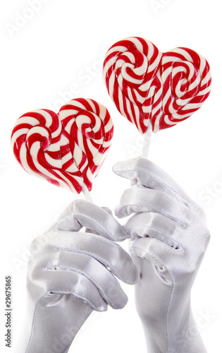 hands holding candies in the shae of a heart photo