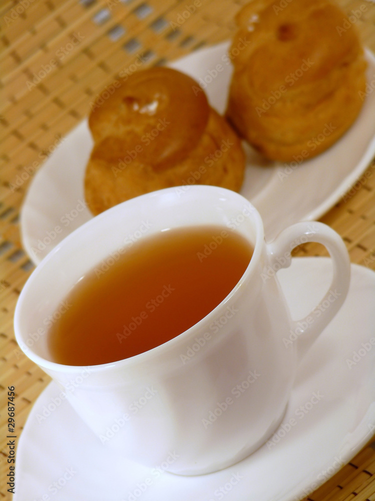 Brewing delicious cake with cream and a cup of tea Brewing delicious cake with cream and a cup of tea