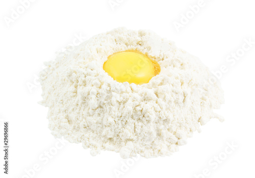 Yellow egg yolk in the flour isolated on white background