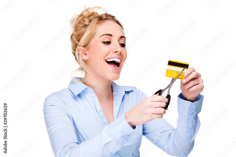 Debt Free - Attractive woman cutting up her credit card Debt Free - Attractive woman cutting up her credit card