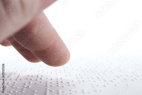 Person reading braille in swedish.