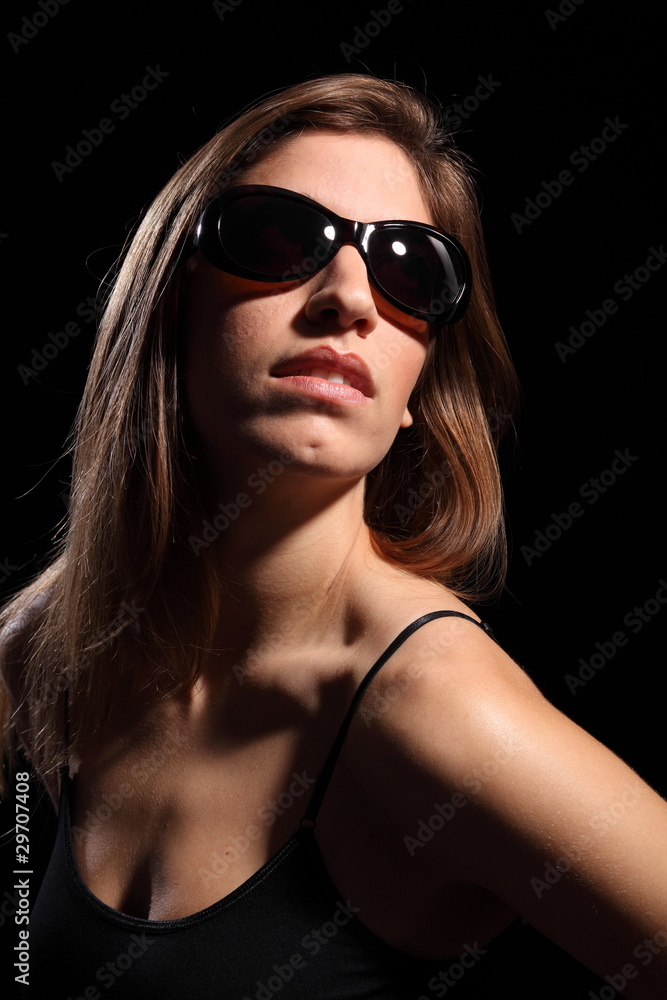 Beautiful young woman wearing dark sunglasses Beautiful young woman wearing dark sunglasses