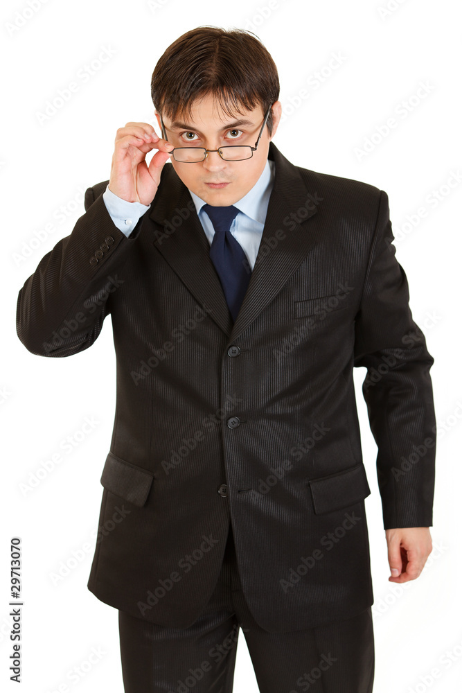 Serious modern businessman straightening eyeglasses Serious modern businessman straightening eyeglasses