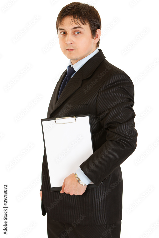 Pensive modern businessman holding blank clipboard in hands Pensive modern businessman holding blank clipboard in hands