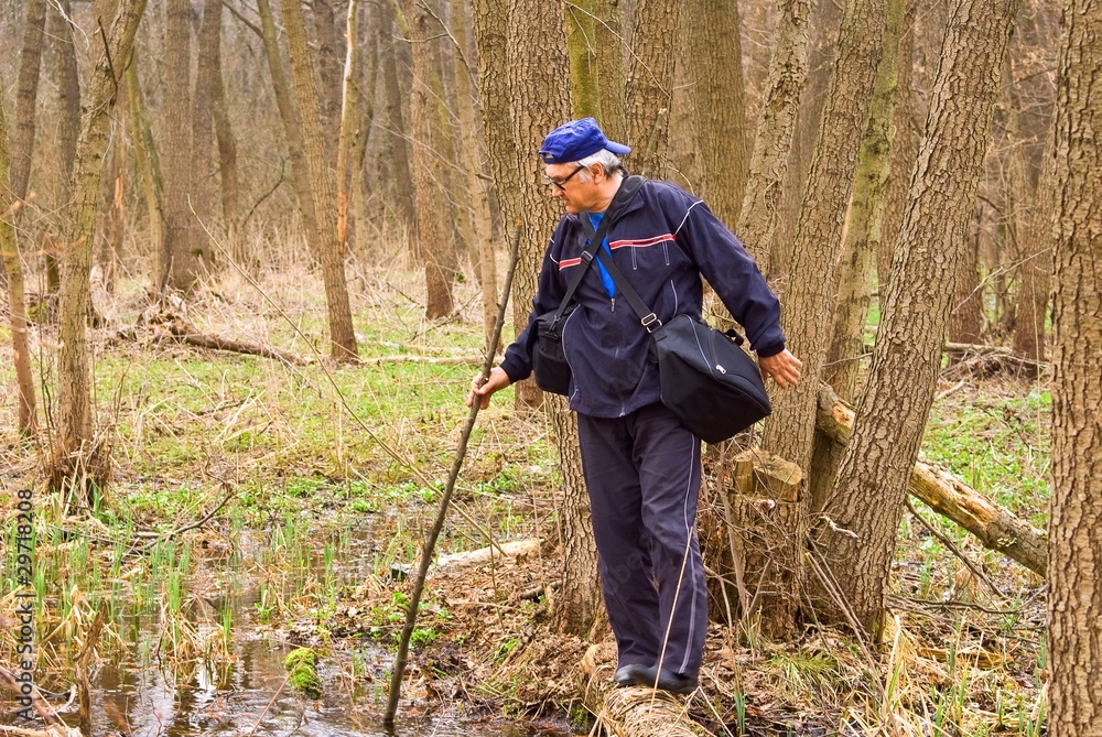 man crossing a swamp man crossing a swamp