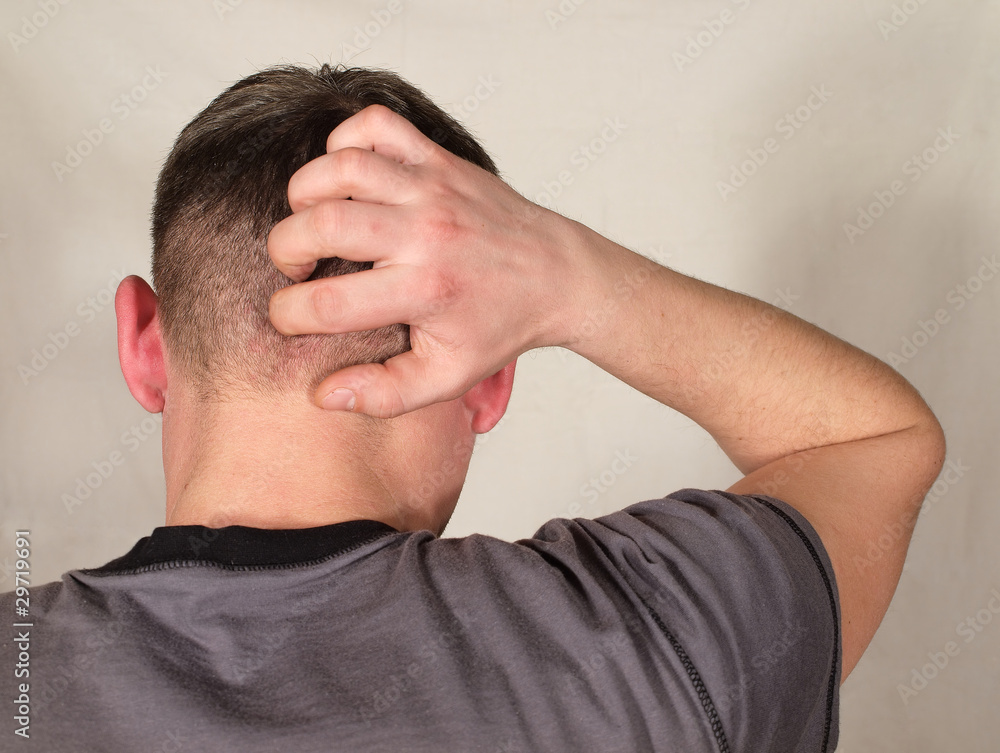 Fototapeta premium Man's hand scratching his head shaved,
