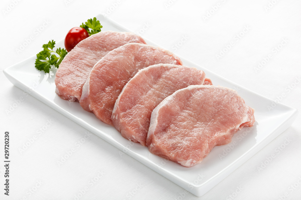 Fresh raw pork on white plate