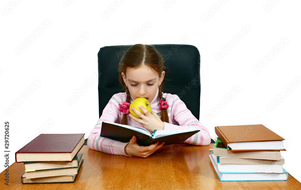 girl which reads a book at the writing table girl which reads a book at the writing table