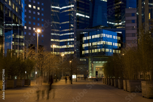 Night street in the middle of the modern city with skyscrapers