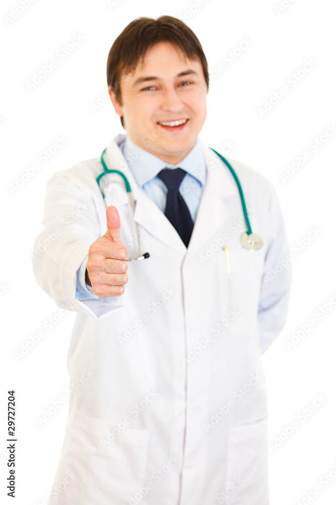 Smiling medical doctor showing thumbs up gesture Smiling medical doctor showing thumbs up gesture