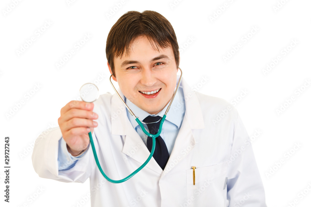 Smiling young medical doctor holding up stethoscope Smiling young medical doctor holding up stethoscope