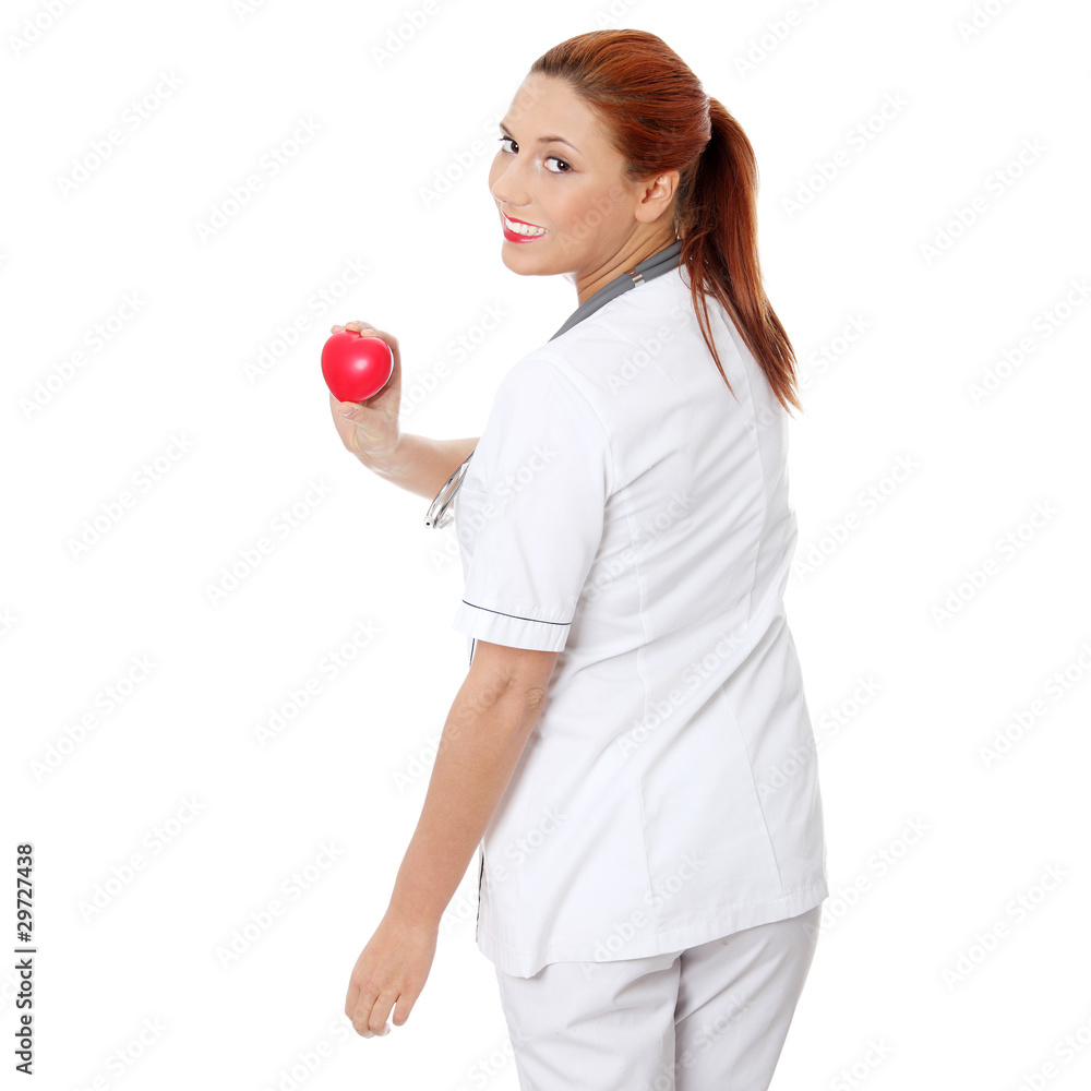 Female doctor with stethoscope holding heart. Female doctor with stethoscope holding heart.