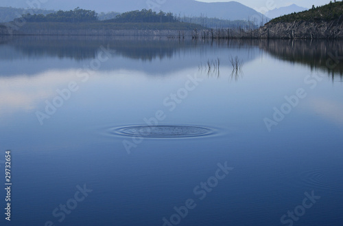 Ripple in still lake misty day