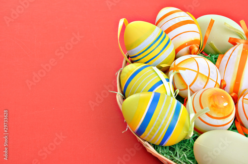 Colorful Easter Eggs basket set on red background