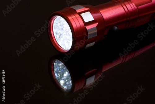 Red handy torch isolated photo