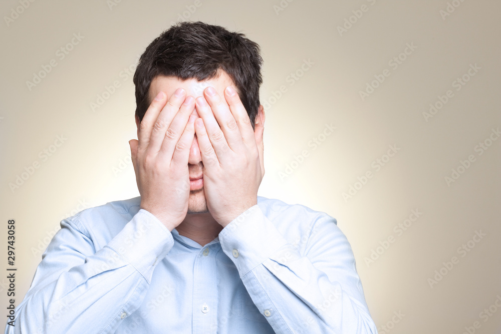 Dramatic portrait of desperated sad man in pain hiding his face Dramatic portrait of desperated sad man in pain hiding his face