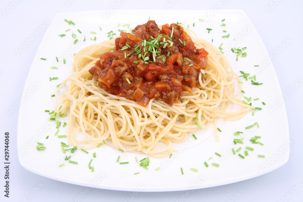 Spaghetti bolognese on a plate decorated with some chives Spaghetti bolognese on a plate decorated with some chives