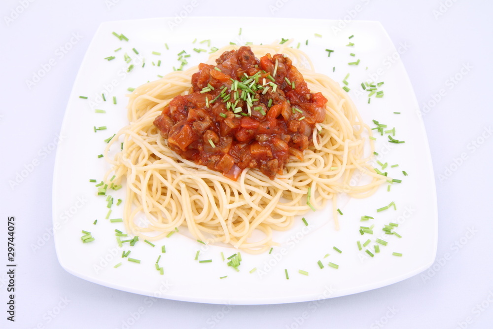 Spaghetti bolognese on a plate decorated with some chives Spaghetti bolognese on a plate decorated with some chives