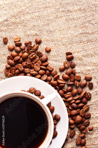 Coffee cup and grain onon a fabric. Still-life photo