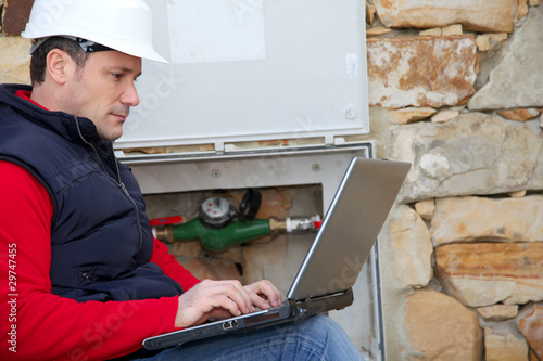 Man reading domestic water consumption photo