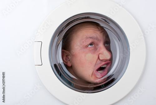 Bizarre man inside washing machine photo