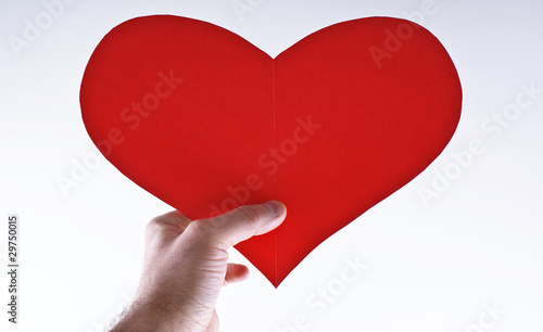 Hand with red paper heart