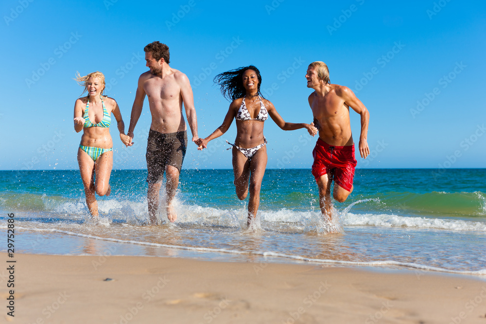 Friends running on beach vacation Friends running on beach vacation