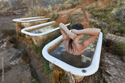 Young woman  relaxing in a hot springs. photo