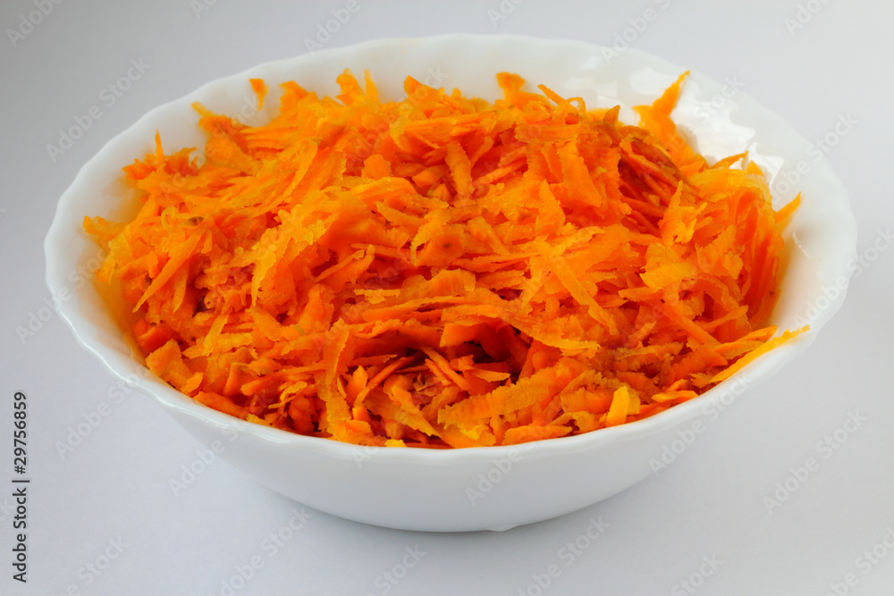 Carrot in the white soup plate Carrot in the white soup plate