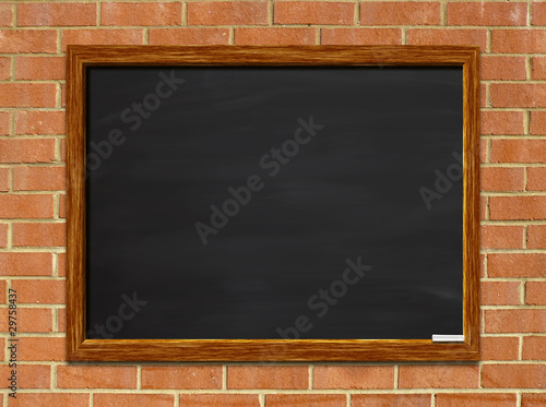 Chalkboard on red brick wall