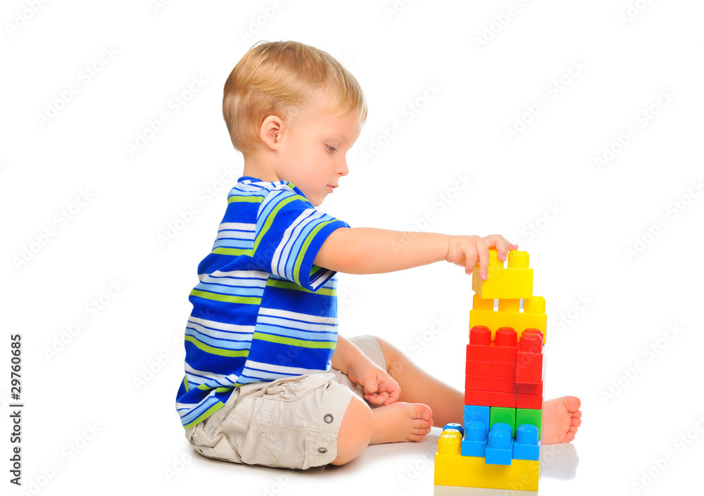 Cute little boy is playing with building blocks Cute little boy is playing with building blocks