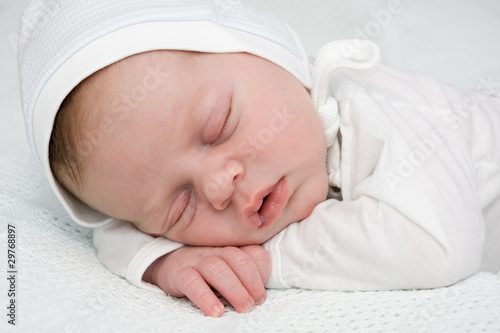 Newborn boy sleeping in cap