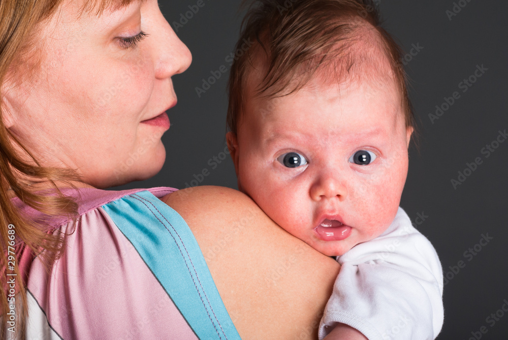 The kid looks out because of a shoulder of mum The kid looks out because of a shoulder of mum